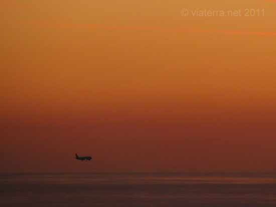 plane landing barcelona sunset